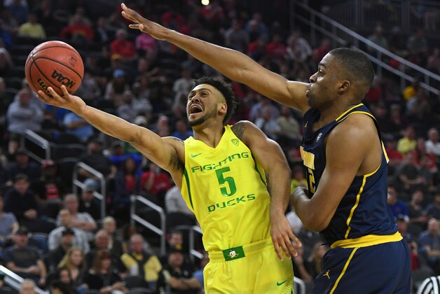 LAS VEGAS, NV - MARCH 10:  Tyler Dorsey #5 of the Oregon Ducks drives to the basket against Kingsley Okoroh #22 of the California Golden Bearsduring a semifinal game of the Pac-12 Basketball Tournament at T-Mobile Arena on March 10, 2016 in Las Vegas, Nevada.  (Photo by Ethan Miller/Getty Images)