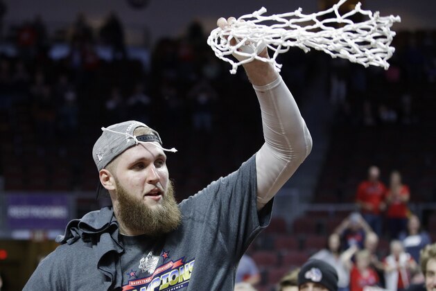 Gonzaga's Przemek Karnowski (24) cuts down the net after defeating Saint Mary's in an NCAA college basketball game during the championship of the West Coast Conference tournament, Tuesday, March 7, 2017, in Las Vegas. Gonzaga won 74-56. (AP Photo/John Locher)