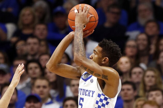 Kentucky's Malik Monk, right, shoots over the defense Florida's Canyon Barry during the second half of an NCAA college basketball game, Saturday, Feb. 25, 2017, in Lexington, Ky. (AP Photo/James Crisp)