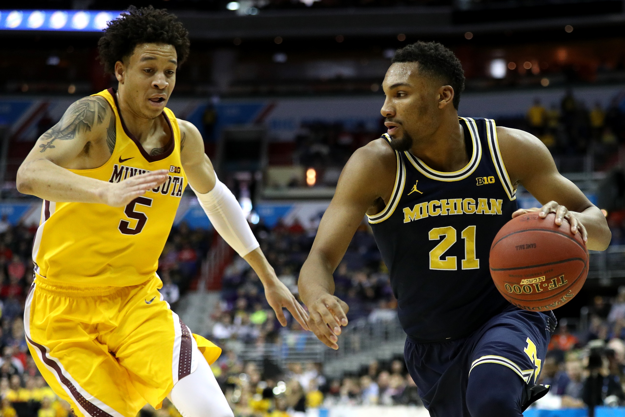 WASHINGTON, DC - MARCH 11: Zak Irvin #21 of the Michigan Wolverines dribbles past Amir Coffey #5 of the Minnesota Golden Gophers during the first half in the semifinals of the Big Ten Basketball Tournament at Verizon Center on March 11, 2017 in Washington, DC. (Photo by Patrick Smith/Getty Images)