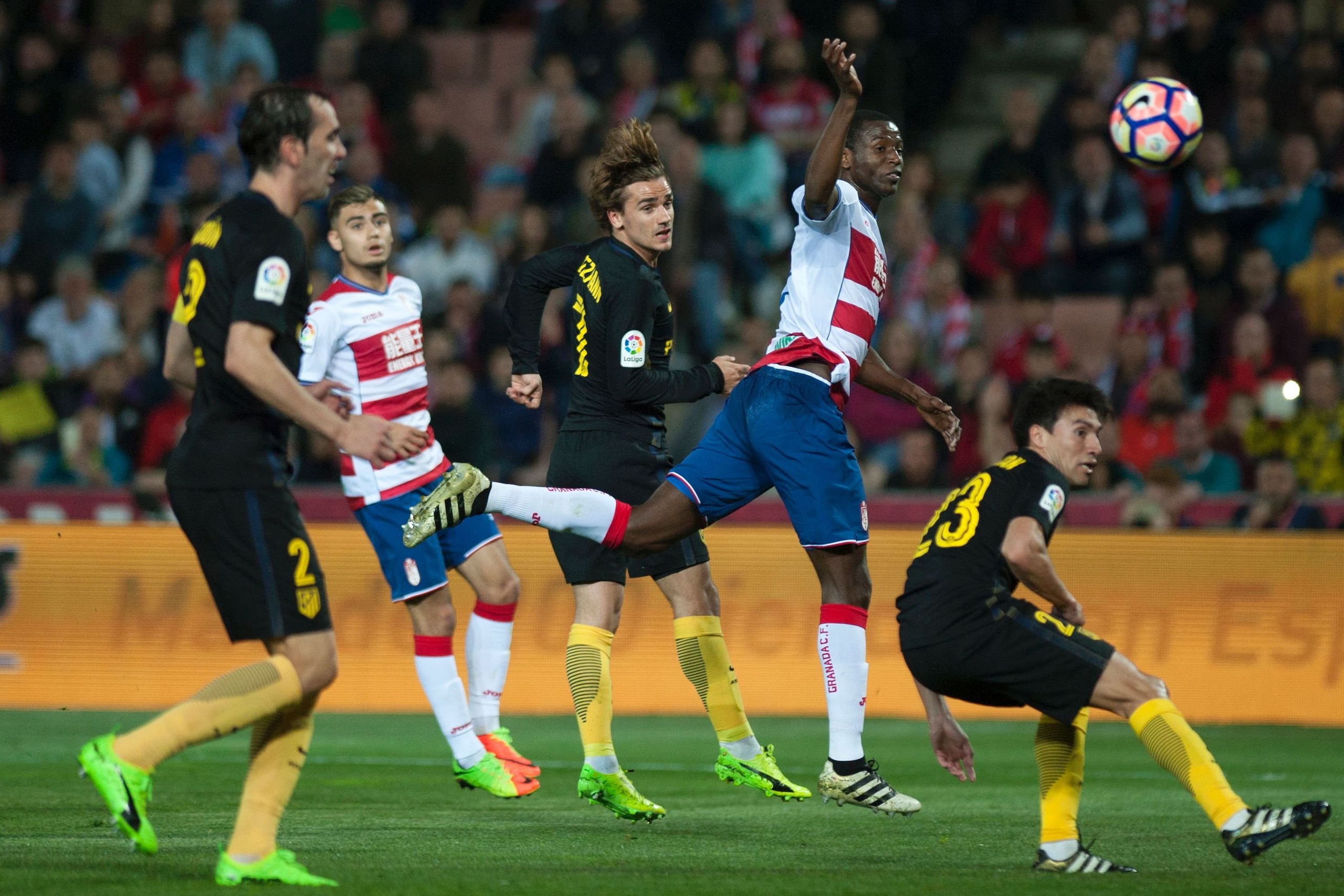 Granada's Colombian forward Adrian Ramos (2ndR) vies with French forward Antoine Griezmann (C) and Argentinian midfielder Nicolas Gaitan (R) during the Spanish league football match Granada CF vs Club Atletico de Madrid at Nuevo Los Carmenes stadium in Granada on March 11, 2017. / AFP PHOTO / JORGE GUERRERO        (Photo credit should read JORGE GUERRERO/AFP/Getty Images)