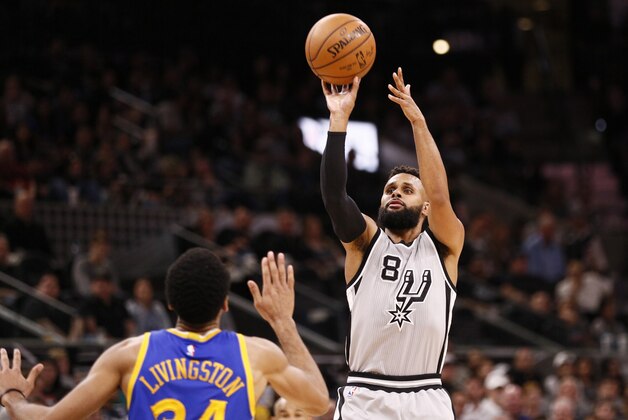 Mar 11, 2017; San Antonio, TX, USA; San Antonio Spurs point guard Patty Mills (8) shoots the ball over Golden State Warriors point guard Shaun Livingston (34) during the first half at AT&T Center. Mandatory Credit: Soobum Im-USA TODAY Sports