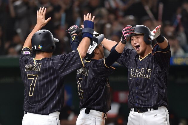 Japan's Sho Nakata (R) celebrates his three-run homer with his teammates, Ryosuke Kikuchi (C) and Norichika Aoki (L) in the top of the third inning during the World Baseball Classic Pool E second round match between Japan and Netherlands at Tokyo Dome in Tokyo on March 12, 2017. / AFP PHOTO / KAZUHIRO NOGI        (Photo credit should read KAZUHIRO NOGI/AFP/Getty Images)