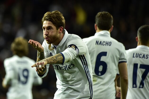 Real Madrid's defender Sergio Ramos celebrates after scoring a goal during the Spanish league footbal match Real Madrid CF vs Real Betis at the Santiago Bernabeu stadium in Madrid on March 12, 2017. / AFP PHOTO / GERARD JULIEN        (Photo credit should read GERARD JULIEN/AFP/Getty Images)