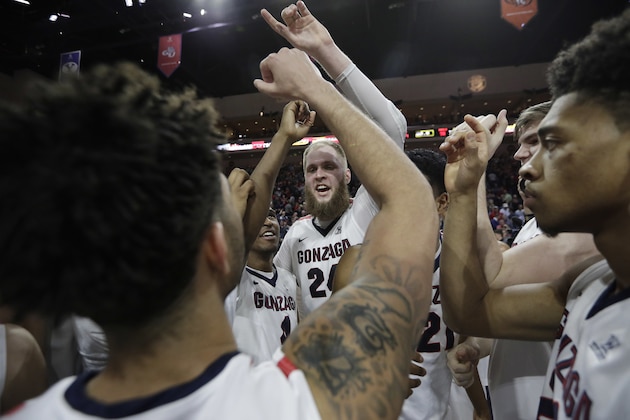 Gonzaga's Przemek Karnowski, center, celebrates with teammates after defeating Saint Mary's in an NCAA college basketball game during the championship of the West Coast Conference tournament, Tuesday, March 7, 2017, in Las Vegas. Gonzaga won 74-56. (AP Photo/John Locher)