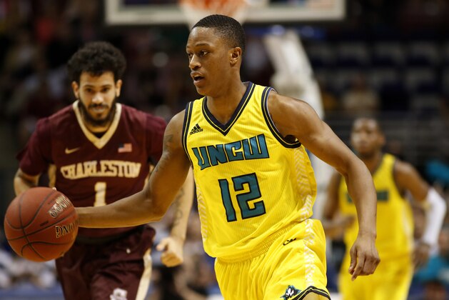 UNC Wilmington's C.J. Bryce, right, dribbles up court against College of Charleston's Grant Riller, left, during the first half of an NCAA college championship basketball game in the Colonial Athletic Association tournament at the North Charleston Coliseum in North Charleston, S.C., Monday, March 6, 2017. (AP Photo/Mic Smith)