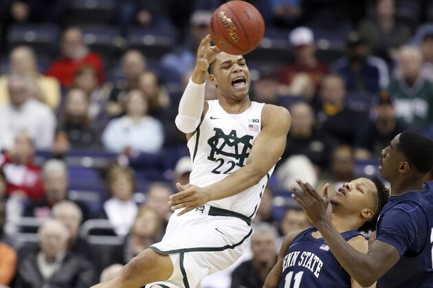 Michigan State guard Miles Bridges (22) passes the ball pat Penn State forwards Lamar Stevens (11) and Mike Watkins (24) during the first half of an NCAA college basketball game in the Big Ten tournament, Thursday, March 9, 2017, in Washington. (AP Photo/Alex Brandon)