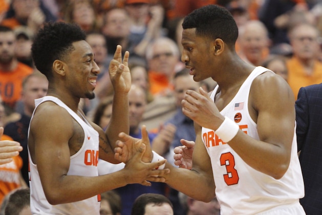 Syracuse's John Gillon, left, and Syracuse's Andrew White III, right, celebrate as White leaves the game in the final minutes of an NCAA college basketball game against Georgia Tech in Syracuse, N.Y., Saturday, March 4, 2017. (AP Photo/Nick Lisi)