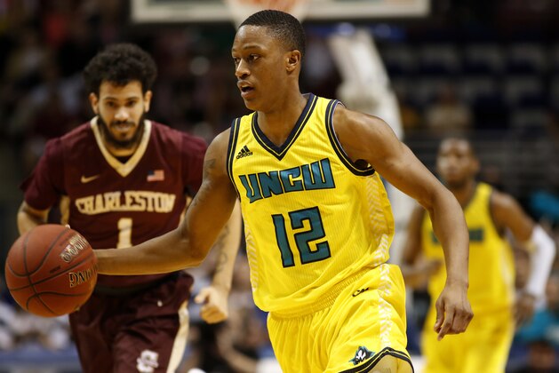 UNC Wilmington's C.J. Bryce, right, dribbles up court against College of Charleston's Grant Riller, left, during the first half of an NCAA college championship basketball game in the Colonial Athletic Association tournament at the North Charleston Coliseum in North Charleston, S.C., Monday, March 6, 2017. (AP Photo/Mic Smith)