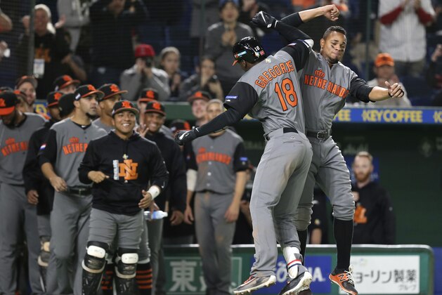 Netherlands' designated hitter Didi Gregorius (18) celebrates with teammates after hitting a three-run home-run off Israel's pitcher Danny Burawa during the fourth inning of their second round game at the World Baseball Classic at Tokyo Dome in Tokyo, Monday, March 13, 2017. (AP Photo/Koji Sasahara)