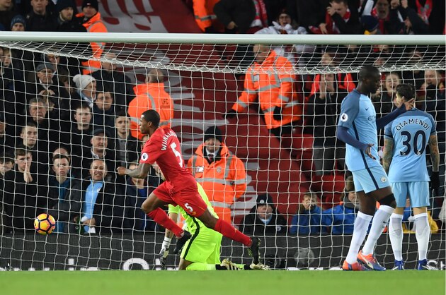 Liverpool's Dutch midfielder Georginio Wijnaldum (C) celebrates after scoring the opening goal of the English Premier League football match between Liverpool and Manchester City at Anfield in Liverpool, north west England on December 31, 2016. / AFP / Paul ELLIS / RESTRICTED TO EDITORIAL USE. No use with unauthorized audio, video, data, fixture lists, club/league logos or 'live' services. Online in-match use limited to 75 images, no video emulation. No use in betting, games or single club/league/player publications.  /         (Photo credit should read PAUL ELLIS/AFP/Getty Images)