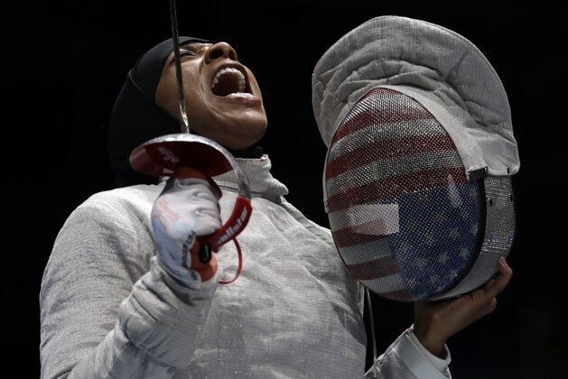 FILE - In this Aug. 13, 2016 file photo, Ibtihaj Muhammad celebrates a point during her women's team sabre fencing semifinal against Russia at the Summer Olympics in Rio de Janeiro, Brazil. Muhammad, the first Muslim-American woman to compete for the U.S. in a hijab, won the bronze. (AP Photo/Andrew Medichini, File)