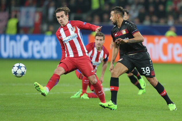 LEVERKUSEN, GERMANY - FEBRUARY 21: Antoine Griezmann of Atletico Madrid and Karim Bellarabi of Bayer Leverkusen battle for the ball during the UEFA Champions League Round of 16 first leg match between Bayer Leverkusen and Club Atletico de Madrid at BayArena on February 21, 2017 in Leverkusen, Germany. (Photo by TF-Images/Getty Images)