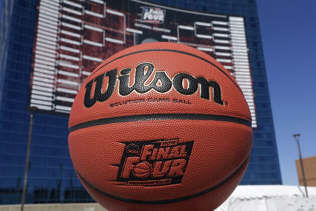 The official Wilson game ball that will be used for the for the NCAA Final Four college basketball games beginning April 4, is shown in front of a giant tournament bracket on the side of the JW Marriott Hotel in Indianapolis, Monday, March 30, 2015. (AP Photo/Michael Conroy)