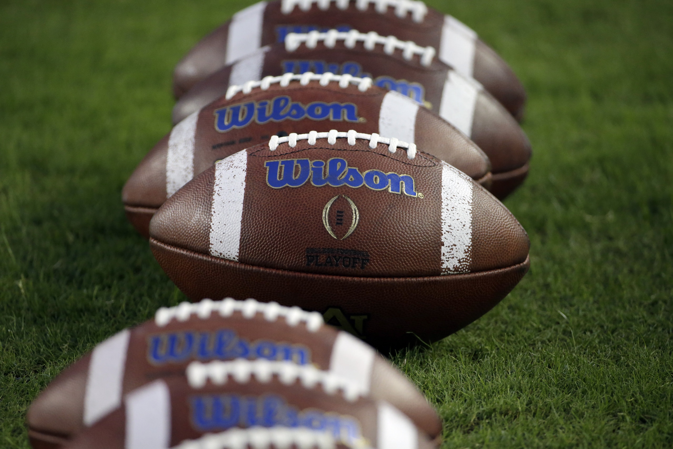 Wilson footballs are lined up on the field before an NCAA college football game between Auburn and Texas A&M Saturday, Nov. 7, 2015, in College Station, Texas. (AP Photo/David J. Phillip)