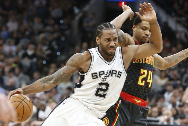 SAN ANTONIO,TX - MARCH 13:  Kawhi Leonard #2 of the San Antonio Spurs drives on Kent Bazemore #24 of the Atlanta Hawks at AT&T Center on March 13, 2017 in San Antonio, Texas.  NOTE TO USER: User expressly acknowledges and agrees that , by downloading and or using this photograph, User is consenting to the terms and conditions of the Getty Images License Agreement. (Photo by Ronald Cortes/Getty Images)