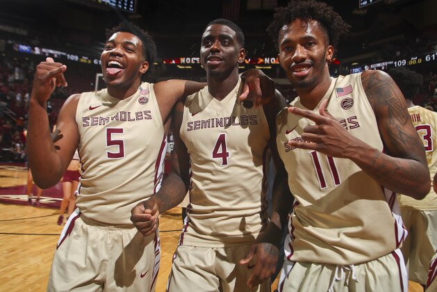 Florida State guards PJ Savoy (5), Dwayne Bacon (4) and Braian Angola-Rodas (11) celebrate after an NCAA college basketball game against Clemson in Tallahassee, Fla., Sunday, Feb. 5, 2017. (AP Photo/Phil Sears)