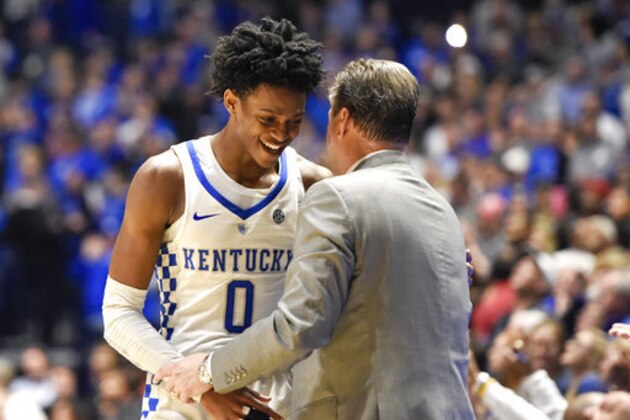 Kentucky guard De'Aaron Fox talks with John Calipari as Fox leaves the game against Arkansas in the second half of an NCAA college basketball game for the championship of the Southeastern Conference tournament Sunday, March 12, 2017, in Nashville, Tenn. Kentucky won 82-65. (AP Photo/Sanford Myers)