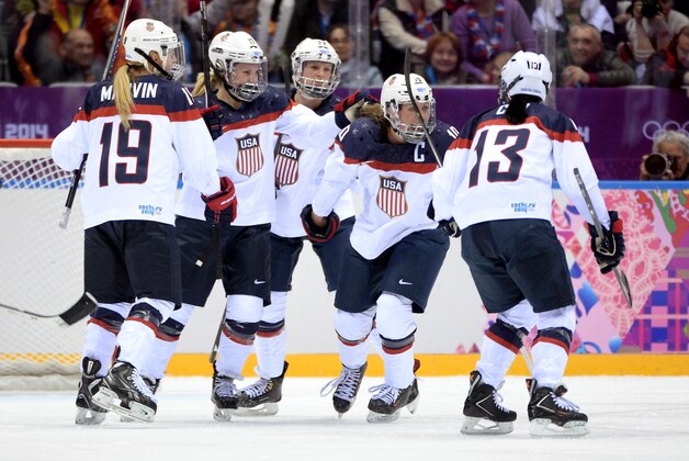 SOCHI, RUSSIA - FEBRUARY 20:  Meghan Duggan #10 of the United States celebrates with teammates Julie Chu #13, Kacey Bellamy #22, Jocelyne Lamoureux #17 and Gigi Marvin #19 after scoring a second-period goal during the Ice Hockey Women's Gold Medal Game on day 13 of the Sochi 2014 Winter Olympics at Bolshoy Ice Dome on February 20, 2014 in Sochi, Russia.  (Photo by Harry How/Getty Images)