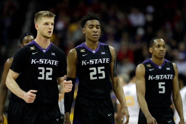 KANSAS CITY, MO - MARCH 10:  Dean Wade #32, Wesley Iwundu #25, and Barry Brown #5 of the Kansas State Wildcats walk off the court during a tineout in the semifinal game of the Big 12 Basketball Tournament against the West Virginia Mountaineers at Sprint Center on March 10, 2017 in Kansas City, Missouri.  (Photo by Jamie Squire/Getty Images)