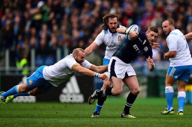 ROME, ITALY - FEBRUARY 27:  Finn Russell of Scotland breaks the tackle of Lorenzo Cittadini of and Joshua Furno of Italy during the RBS Six Nations match between Italy and Scotland at Stadio Olimpico on February 27, 2016 in Rome, Italy.  (Photo by Dan Mullan/Getty Images)