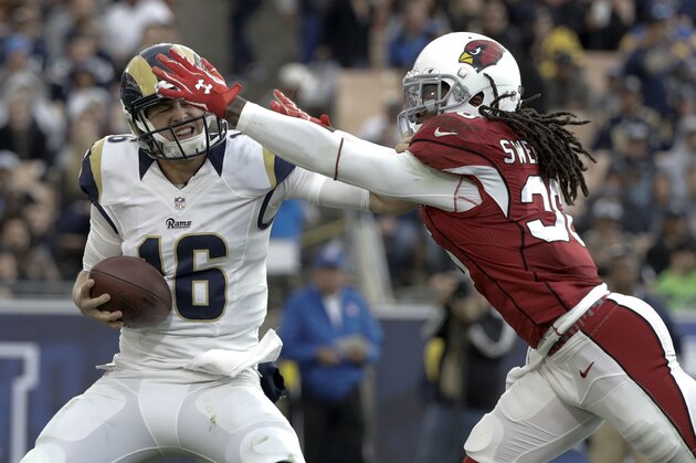 Los Angeles Rams quarterback Jared Goff, left, throws under pressure by Arizona Cardinals free safety D.J. Swearinger during the second half of an NFL football game Sunday, Jan. 1, 2017, in Los Angeles. (AP Photo/Jae C. Hong)
