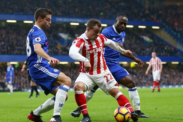 LONDON, ENGLAND - DECEMBER 31: Xherdan Shaqiri (C) of Stoke City controls the ball under pressure of Cesar Azpilicueta (L) and Victor Moses (R) of Chelsea during the Premier League match between Chelsea and Stoke City at Stamford Bridge on December 31, 2016 in London, England.  (Photo by Steve Bardens/Getty Images)