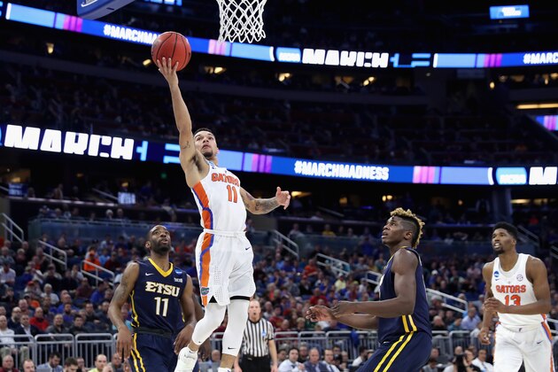 ORLANDO, FL - MARCH 16:  Teammates Desonta Bradford #11 and Hanner Mosquera-Perea #12 of the East Tennessee State Buccaneers watch as Chris Chiozza #11 of the Florida Gators drives to the basket during the first round of the 2017 NCAA Men's Basketball Tournament at Amway Center on March 16, 2017 in Orlando, Florida.  (Photo by Rob Carr/Getty Images)