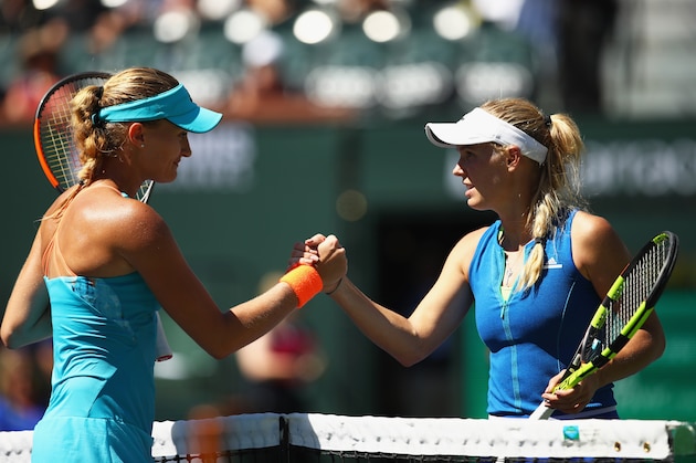 INDIAN WELLS, CA - MARCH 16:  Kristina Mladenovic of France shakes hands at the net after her three set victory against Caroline Wozniacki of Denmark in their quarter final match during day eleven of the BNP Paribas Open at Indian Wells Tennis Garden on March 16, 2017 in Indian Wells, California.  (Photo by Clive Brunskill/Getty Images)