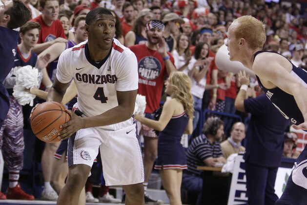 Gonzaga guard Jordan Mathews (4) holds the ball while defended by BYU guard TJ Haws during the first half of an NCAA college basketball game in Spokane, Wash., Saturday, Feb. 25, 2017. (AP Photo/Young Kwak)