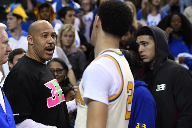 FILE - In this March 4, 2017, file photo, UCLA guard Lonzo Ball, right, shakes hands with his father LaVar following an NCAA college basketball game against Washington State in Los Angeles. UCLA won 77-68. LaVar Ball says his home was broken into while he was attending a high school game involving two of Lonzo Ball’s brothers. (AP Photo/Mark J. Terrill, File)