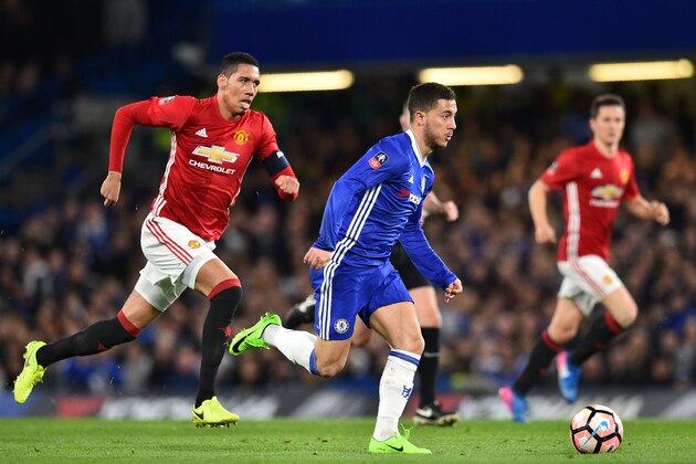 Chelsea's Belgian midfielder Eden Hazard runs with the ball, chased by Manchester United's English defender Chris Smalling (L) during the English FA Cup quarter final football match between Chelsea and Manchester United at Stamford Bridge in London on March 13, 2017. / AFP PHOTO / Glyn KIRK / RESTRICTED TO EDITORIAL USE. No use with unauthorized audio, video, data, fixture lists, club/league logos or 'live' services. Online in-match use limited to 75 images, no video emulation. No use in betting, games or single club/league/player publications.  /         (Photo credit should read GLYN KIRK/AFP/Getty Images)