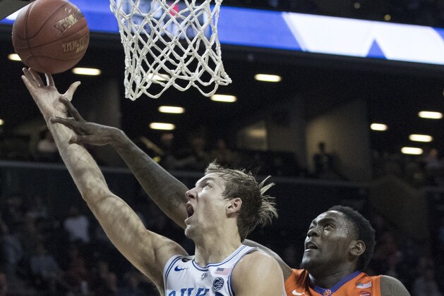 Duke guard Luke Kennard (5) goes to the basket past Clemson forward Elijah Thomas (14) during the second half of an NCAA college basketball game in the Atlantic Coast Conference tournament, Wednesday, March 8, 2017, in New York. Duke won 79-72. (AP Photo/Mary Altaffer)