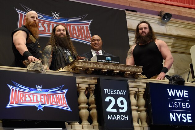 NEW YORK, NY - MARCH 29:  WWE Superstars Erick Rowan, Bray Wyatt and Braun Strowman with NYSE Global head of capital markets Garvis Toler (3rd from left) ring The New York Stock Exchange Opening Bell in honor of WrestleMania 32  at New York Stock Exchange on March 29, 2016 in New York City.  (Photo by Jamie McCarthy/Getty Images)