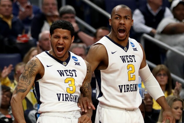 BUFFALO, NY - MARCH 16: James Bolden #3 and Jevon Carter #2 of the West Virginia Mountaineers react from the bench against the Bucknell Bison  during the first round of the 2017 NCAA Men's Basketball Tournament at KeyBank Center on March 16, 2017 in Buffalo, New York.  (Photo by Elsa/Getty Images)