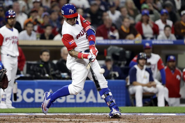 Puerto Rico's Javier Baez breaks his bat as he hits a single during the first inning of a second-round World Baseball Classic baseball game against the United States on Friday, March 17, 2017, in San Diego. (AP Photo/Gregory Bull)