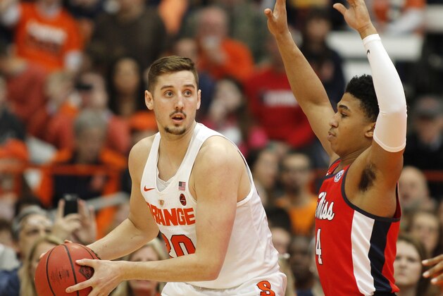 Syracuse's Tyler Lydon, left, looks to pass the ball under pressure from Mississippi's Breein Tyree, right, in the first half of an NCAA college basketball NIT game in Syracuse, N.Y., Saturday, March 18, 2017. (AP Photo/Nick Lisi)