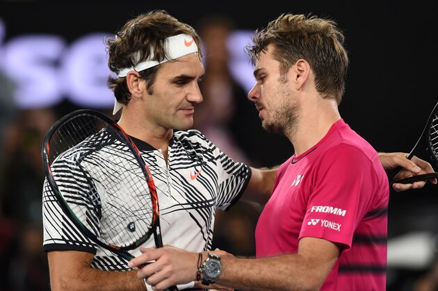 Switzerland's Roger Federer (L) shakes hands with Switzerland's Stanislas Wawrinka during their men's singles semi-final match on day 11 of the Australian Open tennis tournament in Melbourne on January 26, 2017. / AFP / PAUL CROCK / IMAGE RESTRICTED TO EDITORIAL USE - STRICTLY NO COMMERCIAL USE        (Photo credit should read PAUL CROCK/AFP/Getty Images)