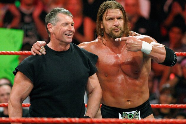 LAS VEGAS - AUGUST 24:  World Wrestling Entertainment Inc. Chairman Vince McMahon (L) and wrestler Triple H appear in the ring during the WWE Monday Night Raw show at the Thomas & Mack Center August 24, 2009 in Las Vegas, Nevada.  (Photo by Ethan Miller/Getty Images)