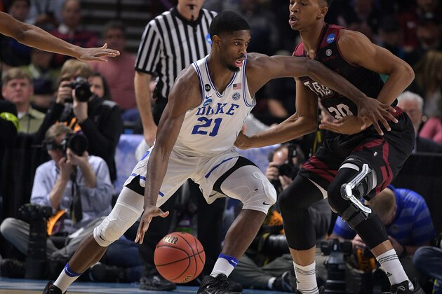 GREENVILLE, SC - MARCH 17: Amile Jefferson #21 of the Duke Blue Devils moves the ball against Alex Hicks #30 of the Troy Trojans during the first round of the 2017 NCAA Men's Basketball Tournament at Bon Secours Wellness Arena on March 17, 2017 in Greenville, South Carolina. (Photo by Lance King/Getty Images)
