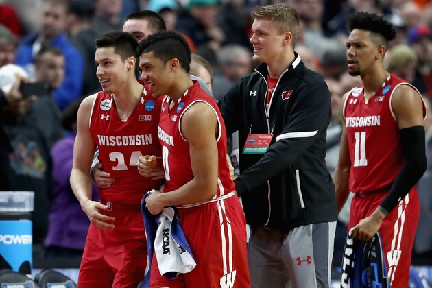 BUFFALO, NY - MARCH 18:  Teammates Bronson Koenig #24 and D'Mitrik Trice #0 of the Wisconsin Badgers celebrate after defeating the Villanova Wildcats 65-62 during the second round of the 2017 NCAA Men's Basketball Tournament at KeyBank Center on March 18, 2017 in Buffalo, New York.  (Photo by Elsa/Getty Images)