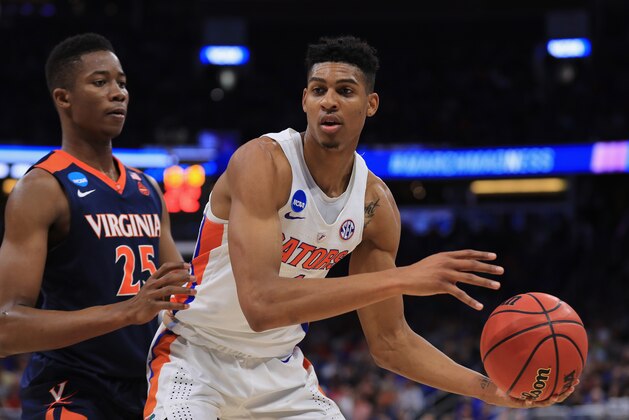 ORLANDO, FL - MARCH 18: Devin Robinson #1 of the Florida Gators looks to pass against Mamadi Diakite #25 of the Virginia Cavaliers in the first half during the second round of the 2017 NCAA Men's Basketball Tournament at the Amway Center on March 18, 2017 in Orlando, Florida.  (Photo by Mike Ehrmann/Getty Images)
