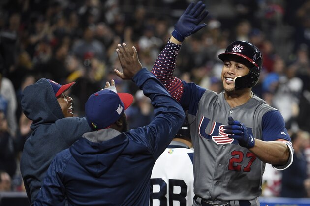 SAN DIEGO, CA - MARCH 18: Giancarlo Stanton #27 of the United States, right, is congratulated after hitting a two run home run during the fourth inning of the World Baseball Classic Pool F Game Six between the United States and the Dominican Republic at PETCO Park on March 18, 2017 in San Diego, California.  (Photo by Denis Poroy/Getty Images)