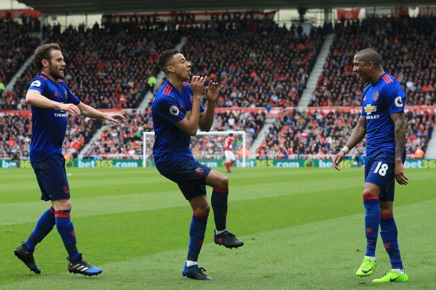 Manchester United's English midfielder Jesse Lingard (C) celebrates with Manchester United's English midfielder Ashley Young (R) and Manchester United's Spanish midfielder Juan Mata (L) after scoring their second goal during the English Premier League football match between Middlesbrough and Manchester United at Riverside Stadium in Middlesbrough, north east England on March 19, 2017. / AFP PHOTO / Lindsey PARNABY / RESTRICTED TO EDITORIAL USE. No use with unauthorized audio, video, data, fixture lists, club/league logos or 'live' services. Online in-match use limited to 75 images, no video emulation. No use in betting, games or single club/league/player publications.  /         (Photo credit should read LINDSEY PARNABY/AFP/Getty Images)