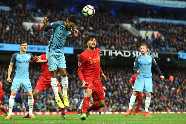 Manchester City's French defender Gael Clichy (L) heads the ball past Liverpool's German midfielder Emre Can during the English Premier League football match between Manchester City and Liverpool at the Etihad Stadium in Manchester, north west England, on March 19, 2017. / AFP PHOTO / PAUL ELLIS / RESTRICTED TO EDITORIAL USE. No use with unauthorized audio, video, data, fixture lists, club/league logos or 'live' services. Online in-match use limited to 75 images, no video emulation. No use in betting, games or single club/league/player publications.  /         (Photo credit should read PAUL ELLIS/AFP/Getty Images)