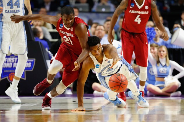 GREENVILLE, SC - MARCH 19:  Manuale Watkins #21 of the Arkansas Razorbacks battles for a loose ball with Isaiah Hicks #4 of the North Carolina Tar Heels in the second half during the second round of the 2017 NCAA Men's Basketball Tournament at Bon Secours Wellness Arena on March 19, 2017 in Greenville, South Carolina.  (Photo by Gregory Shamus/Getty Images)
