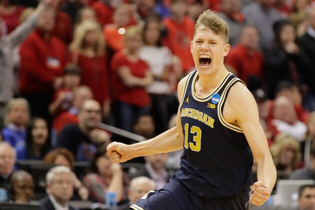 INDIANAPOLIS, IN - MARCH 19:  Moritz Wagner #13 of the Michigan Wolverines celebrates their 73-69 win over the  Louisville Cardinals during the second round of the 2017 NCAA Men's Basketball Tournament at the Bankers Life Fieldhouse on March 19, 2017 in Indianapolis, Indiana.  (Photo by Andy Lyons/Getty Images)