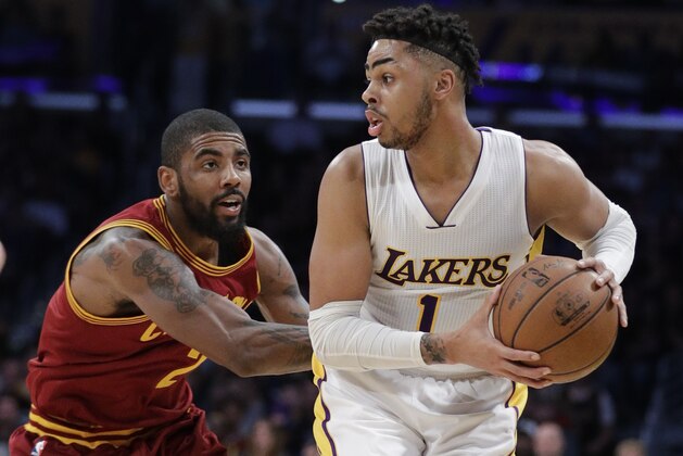 Los Angeles Lakers' D'Angelo Russell, right, is pressured by Cleveland Cavaliers' Kyrie Irving during the first half of an NBA basketball game Sunday, March 19, 2017, in Los Angeles. (AP Photo/Jae C. Hong)