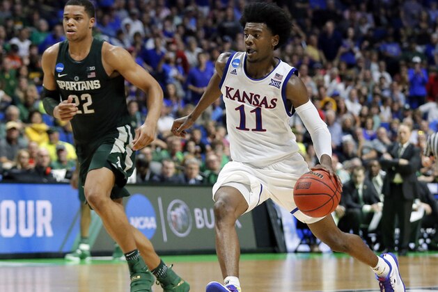 Kansas' Josh Jackson (11) advances the ball to the basket as Michigan State' Miles Bridges (22) gives chase in the second half of a second-round game in the men's NCAA college basketball tournament in Tulsa, Okla., Sunday, March 19, 2017. (AP Photo/Tony Gutierrez)