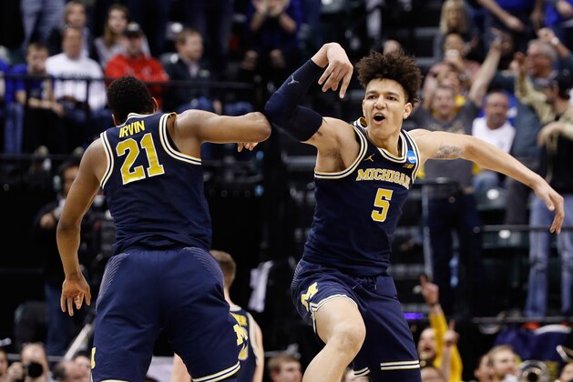 INDIANAPOLIS, IN - MARCH 19:  Muhammad-Ali Abdur-Rahkman #12 and D.J. Wilson #5 of the Michigan Wolverines celebrate in the second half against the Louisville Cardinals during the second round of the 2017 NCAA Men's Basketball Tournament at the Bankers Life Fieldhouse on March 19, 2017 in Indianapolis, Indiana. Michigan Wolverines won 73-69.  (Photo by Joe Robbins/Getty Images)